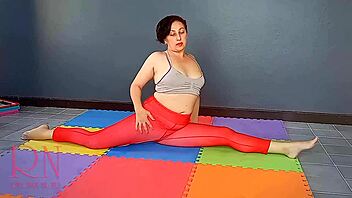 Regina Noir practices yoga in the gym wearing transparent red leotard and pantyhose