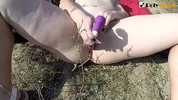 Teen brunette with glasses uses strapon outdoors