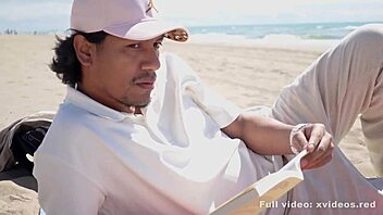 A young man enjoys the calm weather while a woman seduces him on the beach