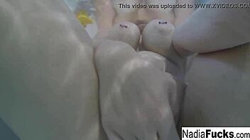 Sexy nadia bathes with rubber duckies