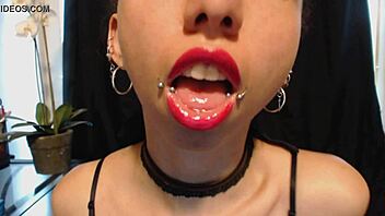 A young and petite girl puts on hot pink lipstick and starts drooling