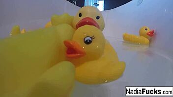 Sexy nadia bathes with rubber duckies