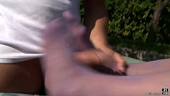 Ally gives footjob to gardener's big cock in the garden!