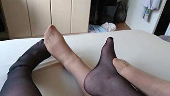 Having fun with my BBW slut's nylon feet on the bed