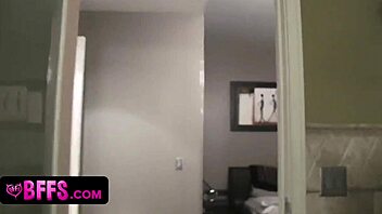 Teen best friends at a pajama party share intimate moments as blonde and brunette.