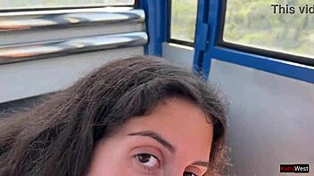 Close up of a beautiful young woman giving a blowjob on a Ferris wheel in an amusement park