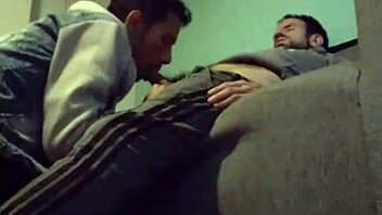 A gay couple enjoys intimate moments with blowjob and sex on the sofa.