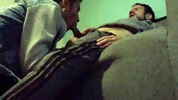 A gay couple enjoys intimate moments with blowjob and sex on the sofa.