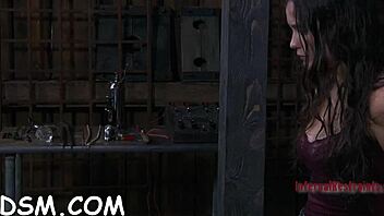 Cheerful brunette slave masturbates with rubber toy in bdsm!