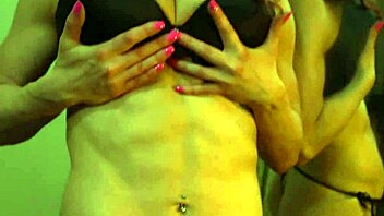 Busty redhead milf shows off her flexible muscles in front of the mirror