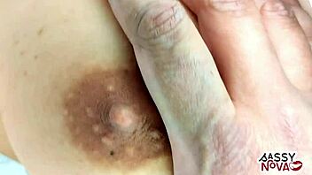 Enjoying the pleasure of her flawless bosom and firm breasts