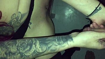 Tattoed goth chick sucks stranger's cock in video booth.