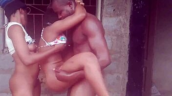 Two ebony girls interact roughly with an African guy.