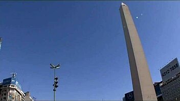 Brunette shemale in crossdressing attire engages in anal activities with cumshot