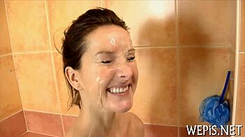 Beautiful woman with hairy genitalia urinates while giving a sloppy blowjob