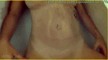 Milf wife gets wet in hotel bath showing big tits