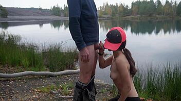 Brunette gives outdoor blowjob by the lake 😊