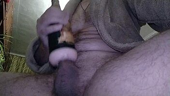 guy jerks off his uncut cock with a toy and cums powerfully