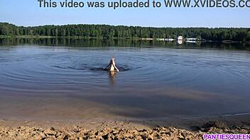 Young woman strips and goes for a swim in the sea in a public beach