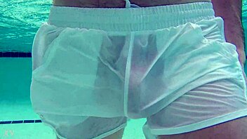Pool boy Xnxxjohn shows off in see-through outfit. Underwater, his big cock is visible.
