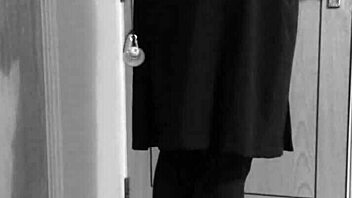 Why is the shemale crossdresser binding herself in handcuffs and uniform?