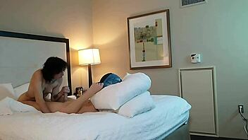 in the dimly lit room, a petite 18+ teen with tattoos eagerly sucks on a massive monster cock, deepthroating it with sloppy enthusiasm