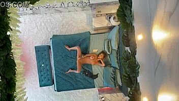 Monika Fox poses naked on the bed, showcasing her pierced nipples and big tits.