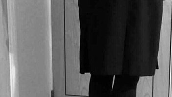 Why is the shemale crossdresser binding herself in handcuffs and uniform?