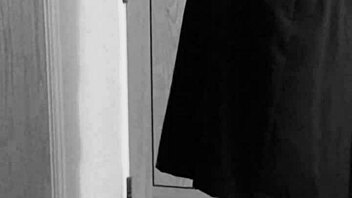 Why is the shemale crossdresser binding herself in handcuffs and uniform?