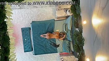 Monika Fox poses naked on the bed, showcasing her pierced nipples and big tits.