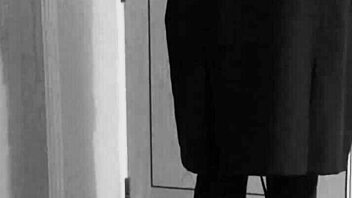 Why is the shemale crossdresser binding herself in handcuffs and uniform?