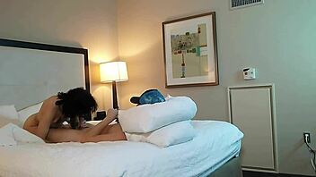 in the dimly lit room, a petite 18+ teen with tattoos eagerly sucks on a massive monster cock, deepthroating it with sloppy enthusiasm