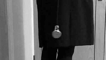 Why is the shemale crossdresser binding herself in handcuffs and uniform?