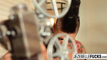 hot jezebelle fingers her tight pussy while teasing on the sofa.