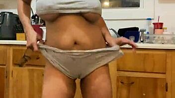 Anna Maria, a mature and sensual Latina woman, performs while washing the dishes