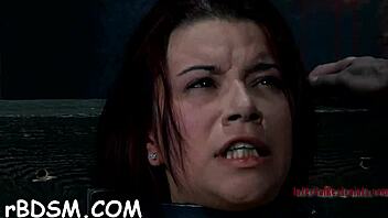 Gagged girl gets her clit pleasured in hardcore BDSM