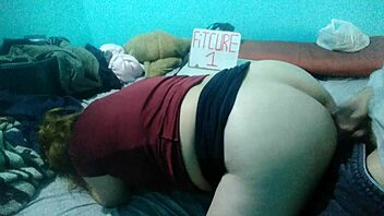 Latina woman bends over on bed