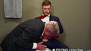 Mature boss dominates employee in bathroom jerking session