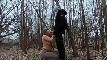 Look at her sucking cock topless in the park!