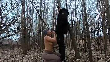 Look at her sucking cock topless in the park!