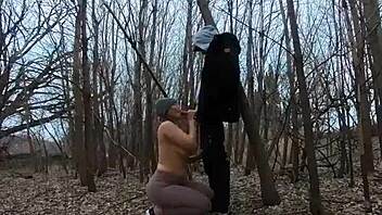 Look at her sucking cock topless in the park!