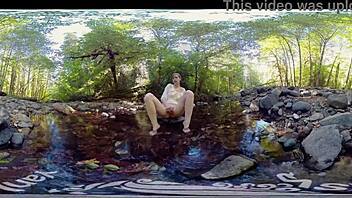 A young red-haired woman masturbates outdoors and shows off her small perky breasts