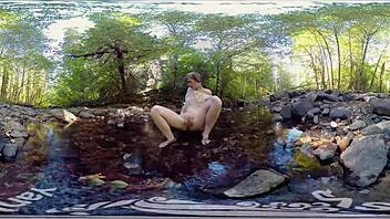 A young red-haired woman masturbates outdoors and shows off her small perky breasts