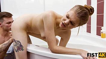 Teen couple feels intense pleasure during fisting in the bath
