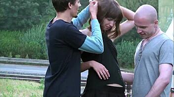 Wanna see a pretty young woman take on two huge cocks publicly?