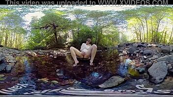 A young red-haired woman masturbates outdoors and shows off her small perky breasts