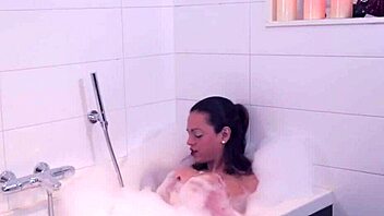 why does the shemale tug her big tits in the bath?
