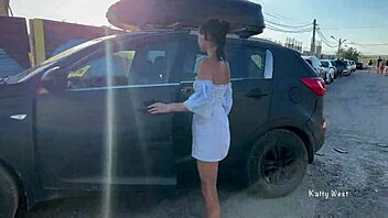 Two young women go topless and expose their private parts in a public place