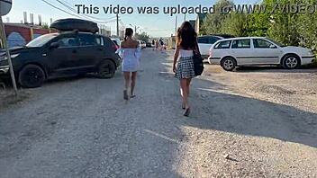 Two young women go topless and expose their private parts in a public place
