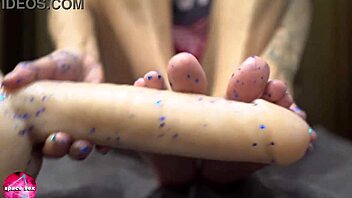 wow, watch this babe give a sensual footjob to a rubber cock in this foot fetish scene!